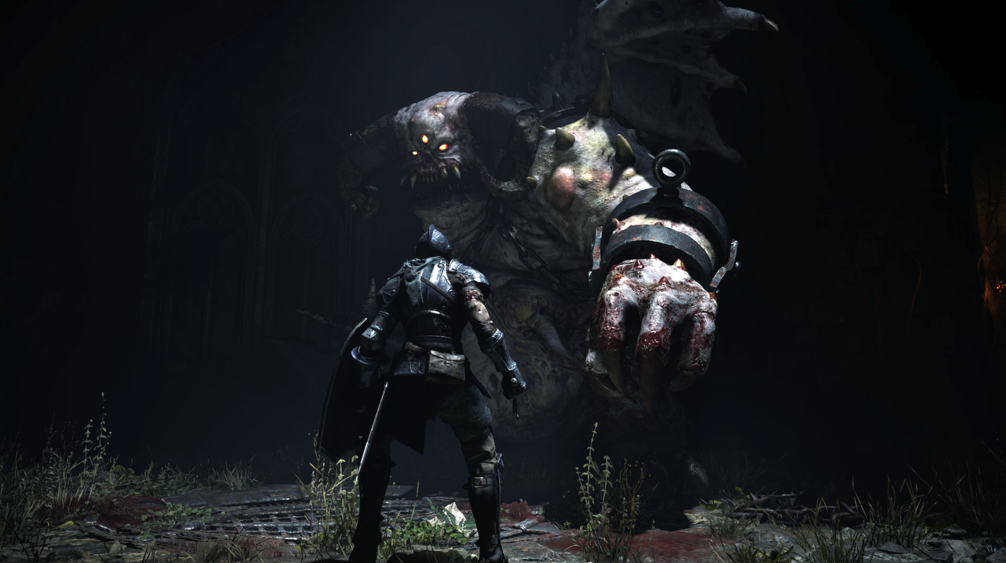 The player staring down a giant demon stepping out of the shadows.