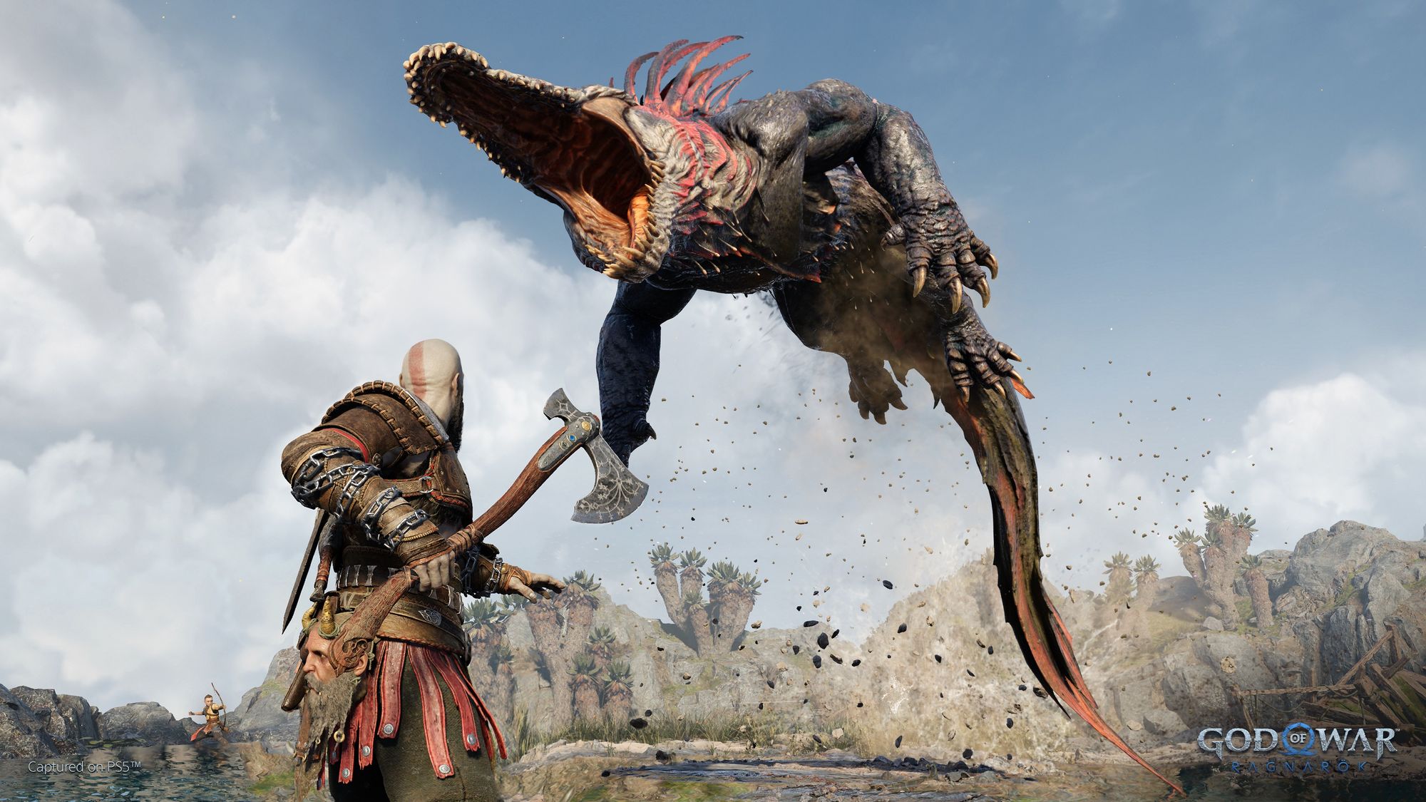 Capture shot of Kratos and Atreus fighintg a weird aligator thing